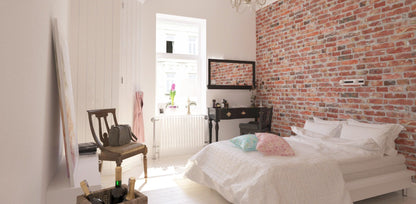 Chambre cosy avec mur en parement brique rouge en tête de lit - ambiance loft parisien