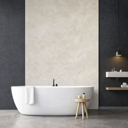 Panneau mural PVC effet béton ciré beige installé dans une salle de bain moderne avec baignoire îlot
